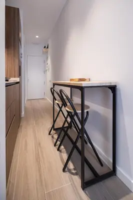 a kitchen with a table with two chairs under it at Yard Patraix by Concept Flats in Valencia