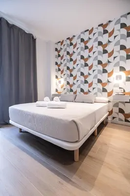 a bedroom with a large bed in a room at Yard Patraix by Concept Flats in Valencia