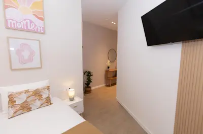 a bedroom with a bed and a flat screen tv at Apartment Casa Novi - Close to Beach, City Center & Metro in Valencia