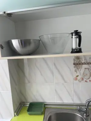 a kitchen with a microwave and plates on a shelf at Habitación Matrimonio en vivienda para compartir recién reformada in Valencia