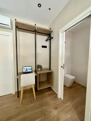 a bathroom with a desk and a laptop on a table at Blue House Valencia in Valencia