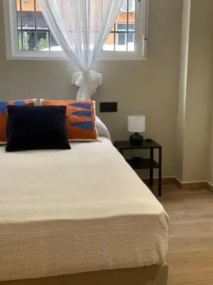 a bedroom with a large bed with a window at Blue House Valencia in Valencia