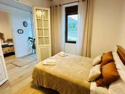 a bedroom with a large bed and a window at La Teja in Losa del Obispo