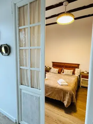 a bedroom with a bed and a large glass door at La Teja in Losa del Obispo