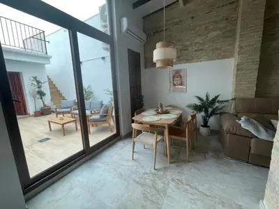 a living room with a table and a couch at Dream Big with jacuzzi and terrace in Ruzafa in Valencia