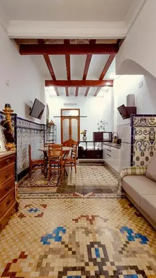 a living room with a couch and a table at Casa del Cabanal La Playa Azul cobalto in Valencia
