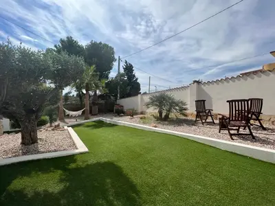 a small yard with a green lawn at Villa con piscina en la montaña in Llombay