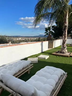 a row of white pillows sitting on the grass at Villa con piscina en la montaña in Llombay