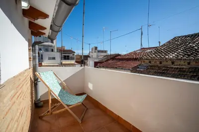 a chair sitting on a balcony with a view at Apto 3 P Ferrandis in Valencia