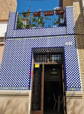 a blue and white building with a balcony at casa del Cabanyal La Playa in Valencia