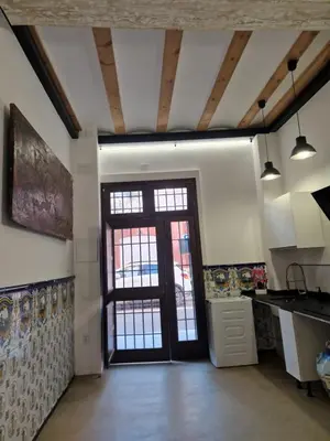 a kitchen with a large door in a room at casa del Cabanyal La Playa in Valencia
