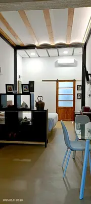 a room with a bed and a table and a chair at casa del Cabanyal La Playa in Valencia