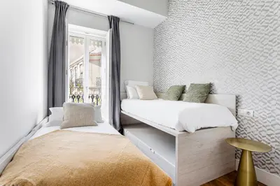 two beds in a small room with a window at Valencia City Apartment with Gym Pool Free Parking TheHavenEscape in Valencia