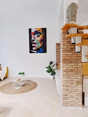 a living room with a bust of a man on the wall at Loft DobleAltura Escalante in Valencia