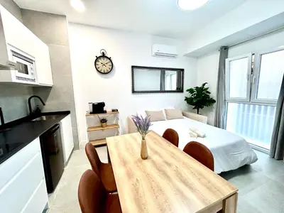 a bedroom with a bed and a table and a clock at Strategic Stay-Unlock Valencia's Best-Kept Secret in Valencia