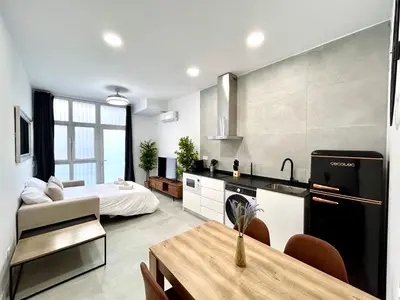 a kitchen and living room with a bed and a table at Valencia Urban Escape Comfort Meets Luxury, 4 Ppl in Valencia