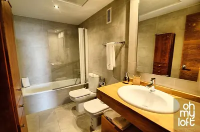 a bathroom with a sink and a toilet and a tub at Ohmyloft Valencia in Burjasot