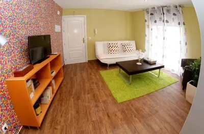 a living room with a couch and a tv at Apartamento Gutenberg in Valencia