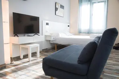 a living room with a couch and a bed at District Key - Carricola in Valencia
