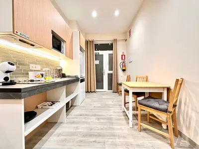 a kitchen with a table and a dining room at Lofts Casa Tropicana in Valencia