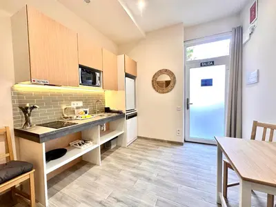 a kitchen with a counter and a table in a room at Lofts Casa Tropicana in Valencia