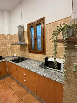a kitchen with a counter top with a microwave at Paraiso Natural Unico -Villa Cueva Turche in Valencia