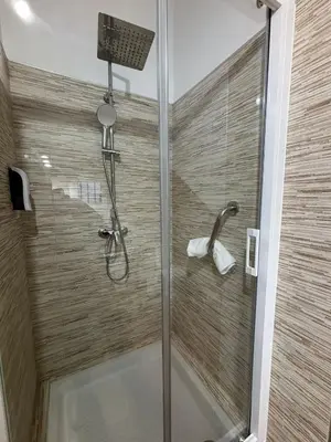 a shower with a glass door in a bathroom at Paraiso Natural Unico -Villa Cueva Turche in Valencia