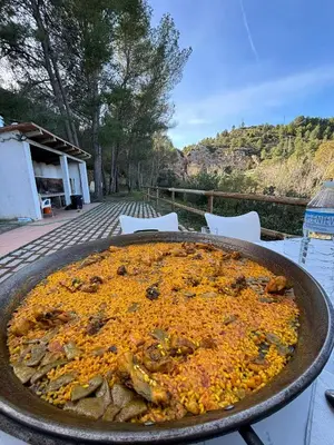 a large pizza in a pan on a table at Paraiso Natural Unico -Villa Cueva Turche in Valencia