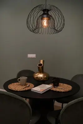 a table with two cups and a vase on it at Green Luxury Zamenhof in Valencia
