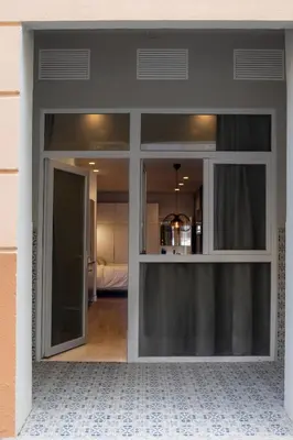 a sliding glass door into a room with a bedroom at Green Luxury Zamenhof in Valencia