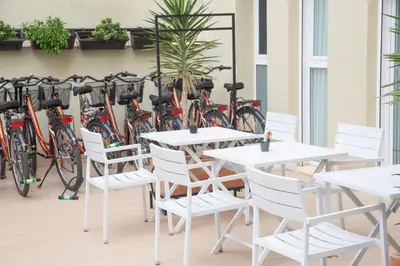 a group of bikes parked next to tables and chairs at Zalamera BnB in Valencia