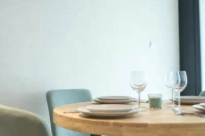 a wooden table with plates and wine glasses on it at District Key - Valencia, Olimpia 2 in Valencia