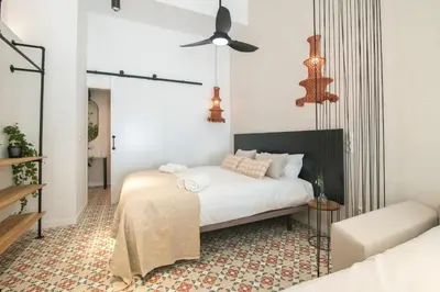 a bedroom with a bed and a ceiling fan at District Key - Valencia, Olimpia 2 in Valencia