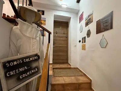 a hallway with a staircase with a sign on the wall at Casa Rural El Mediterraneo Complejo Rural El Colmenar in Chóvar