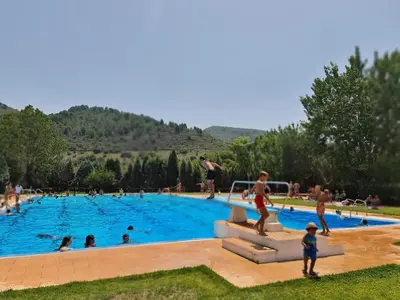 a group of people in a swimming pool at Casa Rural El Mediterraneo Complejo Rural El Colmenar in Chóvar