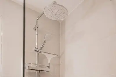 a shower in a bathroom with a glass wall at Suite Guillem Jáfer - Roig Arena in Valencia