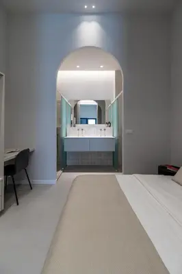 a bedroom with a large bed and a mirror at Valencia Malvarrosa point white in Valencia