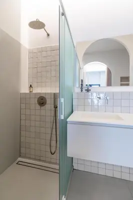 a bathroom with a shower and a sink at Valencia Malvarrosa point white in Valencia