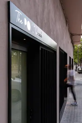 a person walking past the door of a building at Valencia Malvarrosa point white in Valencia