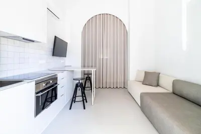 a living room with a couch and a table at Valencia Malvarrosa point white in Valencia
