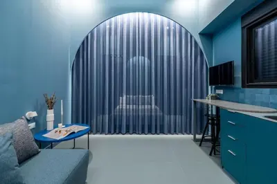 a blue kitchen with a couch and a table at Valencia Malvarrosa beach point blue in Valencia