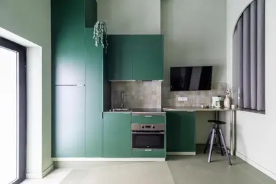 a green kitchen with a stove and a counter at Valencia Malvarrosa Beach point green in Valencia