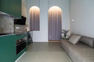 a living room with a couch and a kitchen at Valencia Malvarrosa Beach point green in Valencia