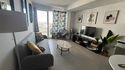 a living room with a couch and a tv at Gran Canet, relax y confort a pocos pasos del mar in Canet de Berenguer
