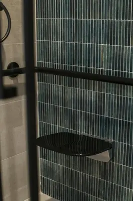 a glass shower door with a black shelf in a bathroom at District Key - Valencia, O Arocena 1 in Valencia