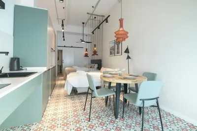 a kitchen and dining room with a table and chairs at District Key - Valencia, O Arocena 1 in Valencia