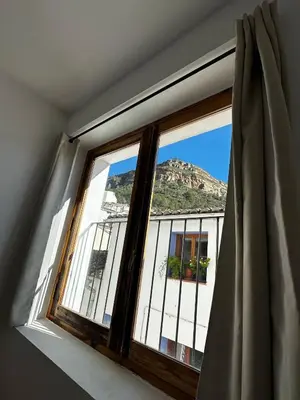 a window with a view of a building at Casa Durá in Chulilla