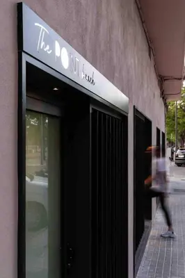 a person walking past a building with a sign on it at Valencia Malvarrosa point beige in Valencia