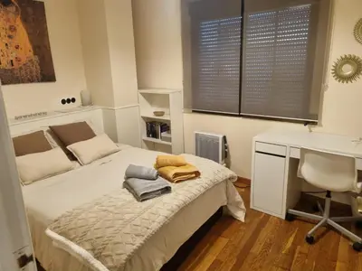 a bedroom with a bed and a desk and a desk at Les Dos Nines in Monserrat