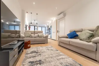a bedroom with a large bed and a table at Che Loft! Artes y Ciencias in Valencia